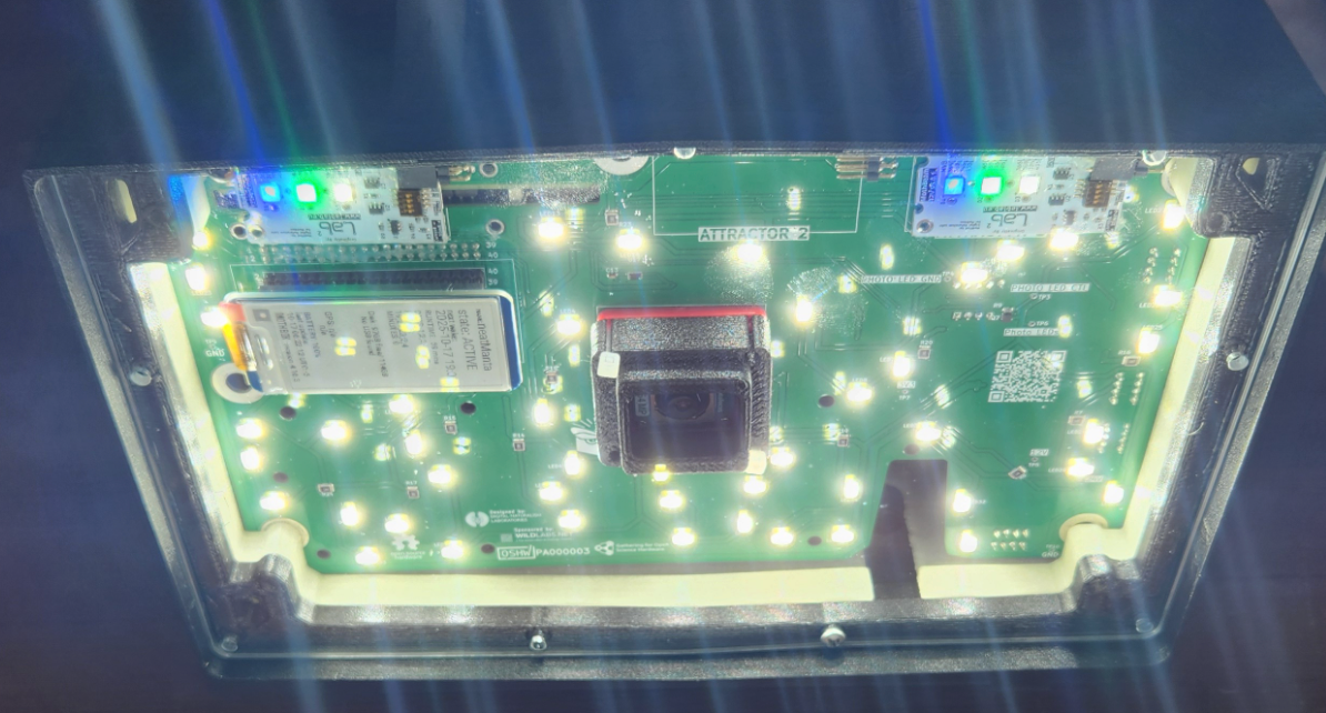 Photo of the most recent design of the Mothbox with lights shining through the acrylic on the front of the housing